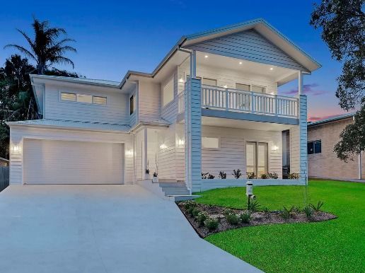 A Large White House with A Large Garage and A Balcony — Blue Horizon Projects in Bateau Bay, NSW