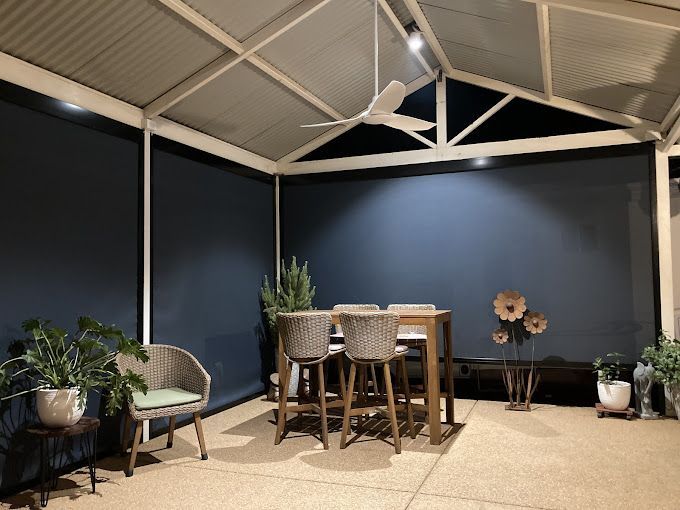 A Patio With A Table And Chairs And A Ceiling Fan — Des Mullins Electrical & Solar In Wagga Wagga, NSW