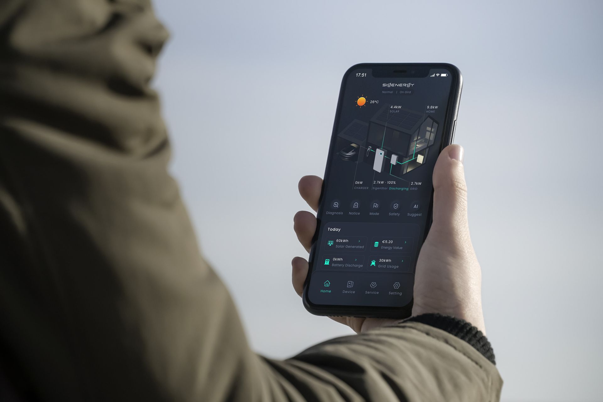 Close-up image of someone holding a phone, looking at the mySigen app.