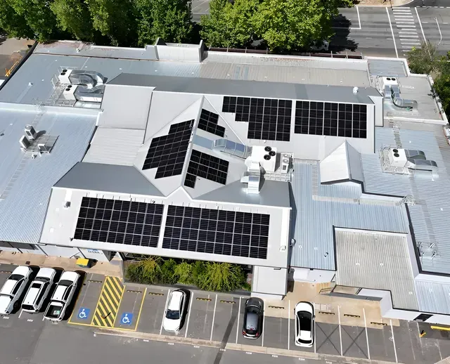 Aerial View of a Building Rooftop With Solar Panels Installed — Des Mullins Electrical & Solar In Wagga Wagga, NSW
