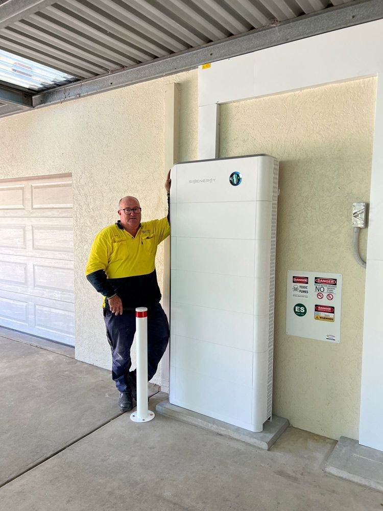 Electrician Standing Next to An Integrated Solar Inverter