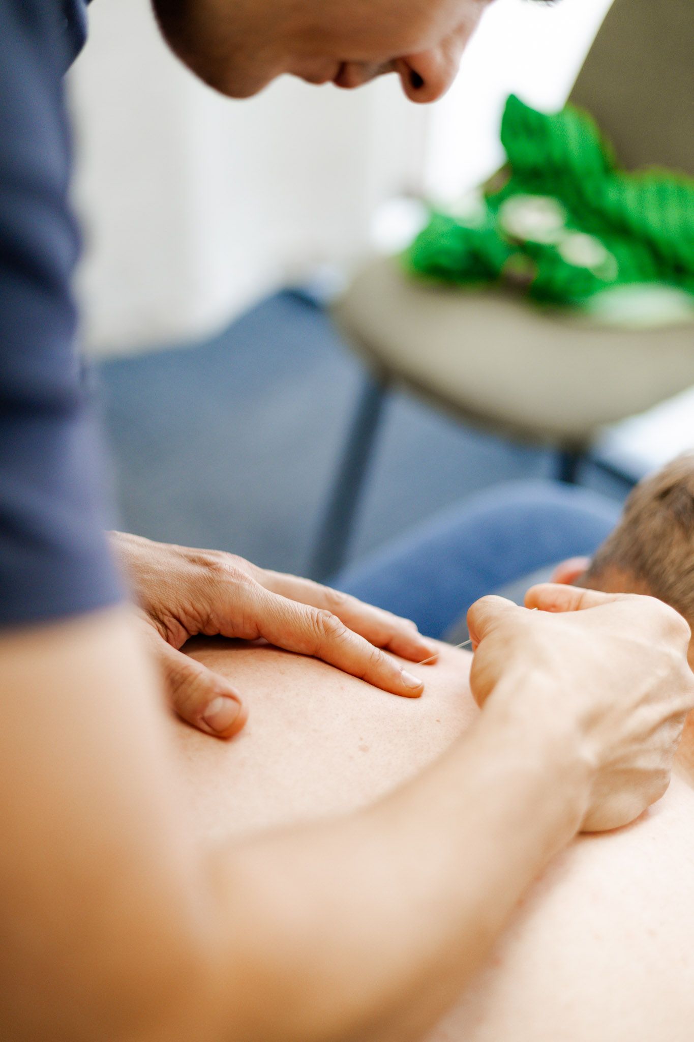 A man is giving a woman a massage on her back