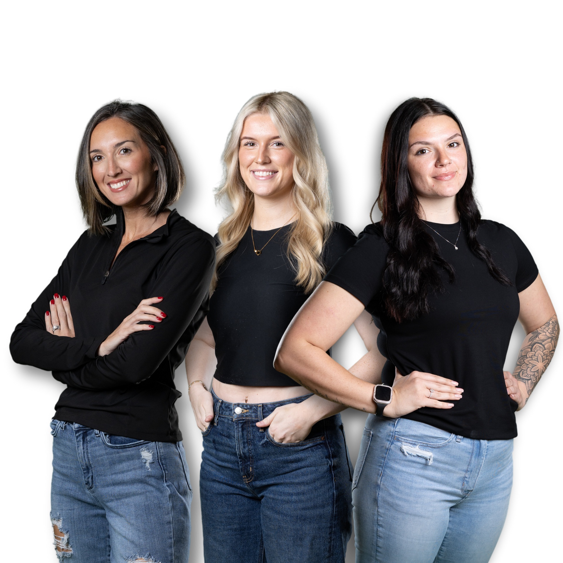 Three smiling individuals in black tops and jeans pose together against a plain white background.