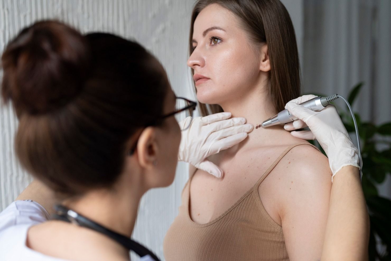 A person receiving cosmetic treatment on their neck from a medical professional.