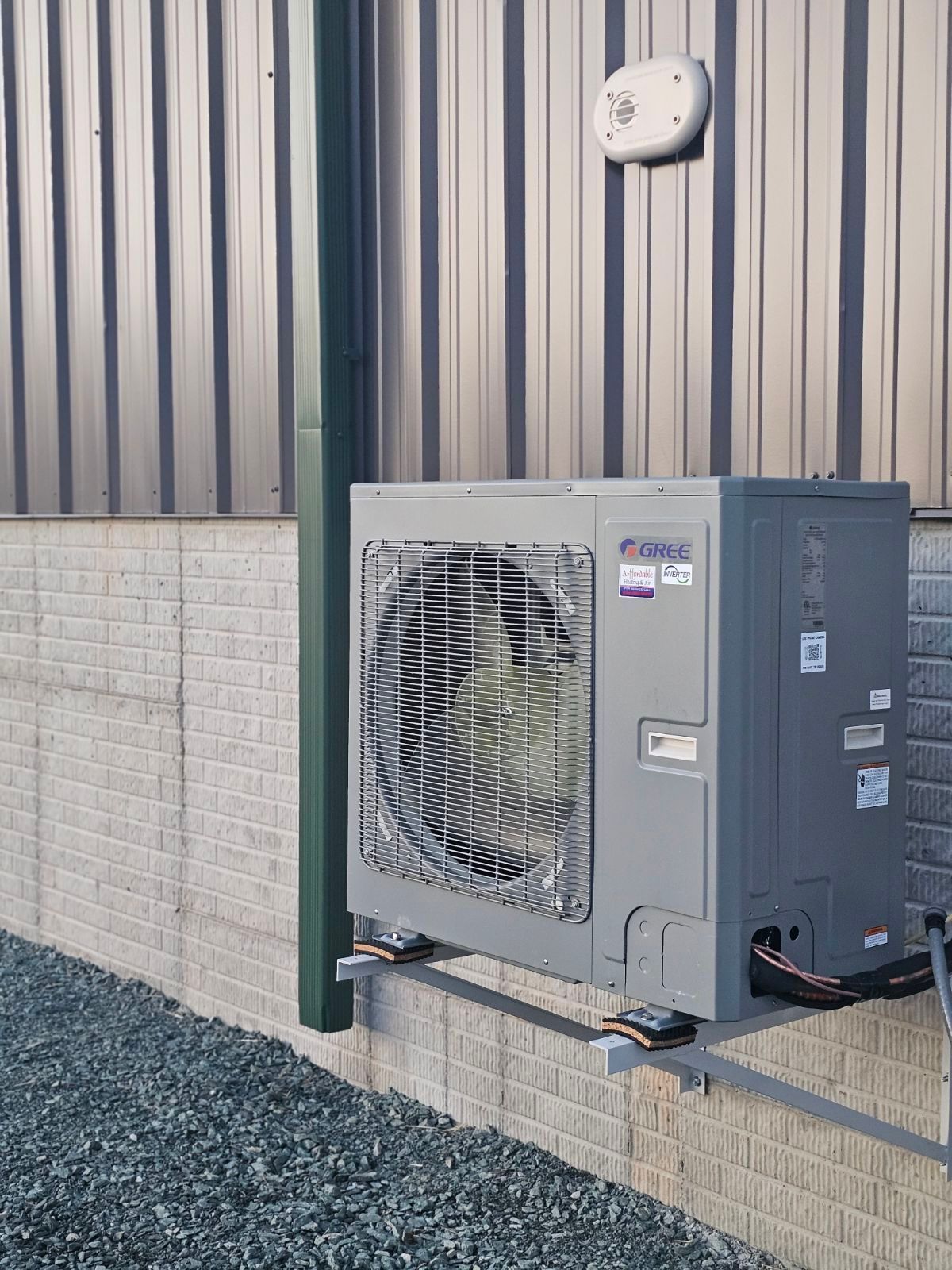 A large air conditioner is mounted on the side of a building.