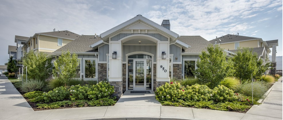 a large house with a lot of windows and trees in front of it .