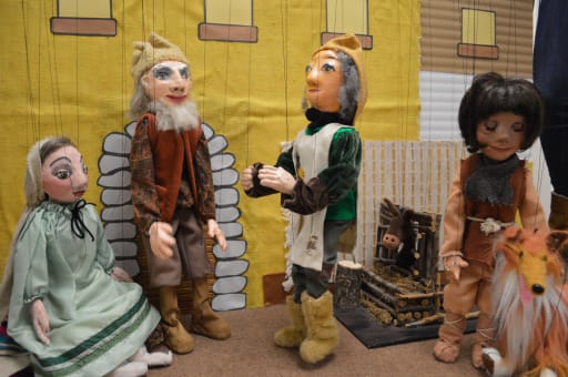 two rustic character marionettes