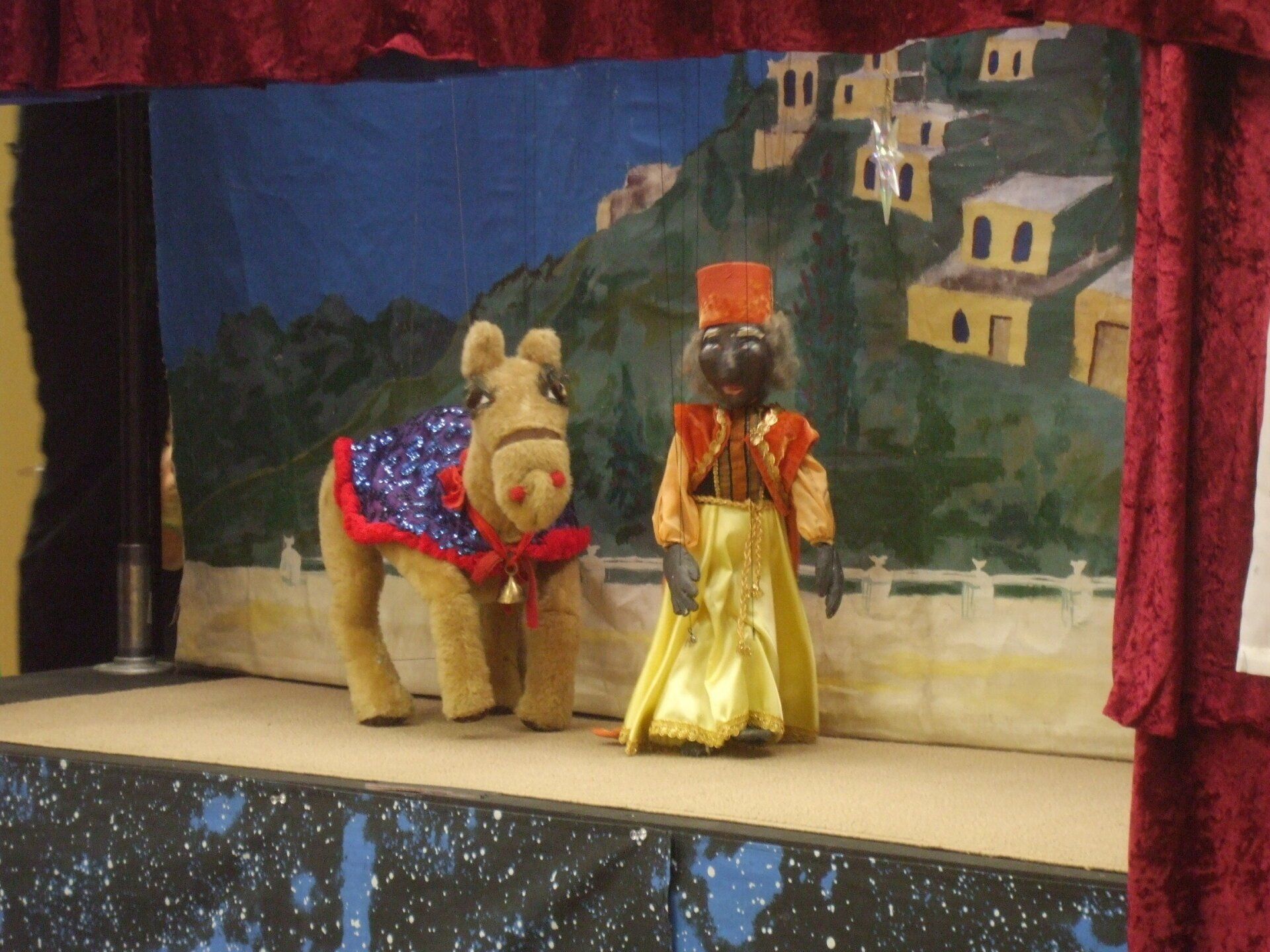 The Wiseman leads the Camel across the stage