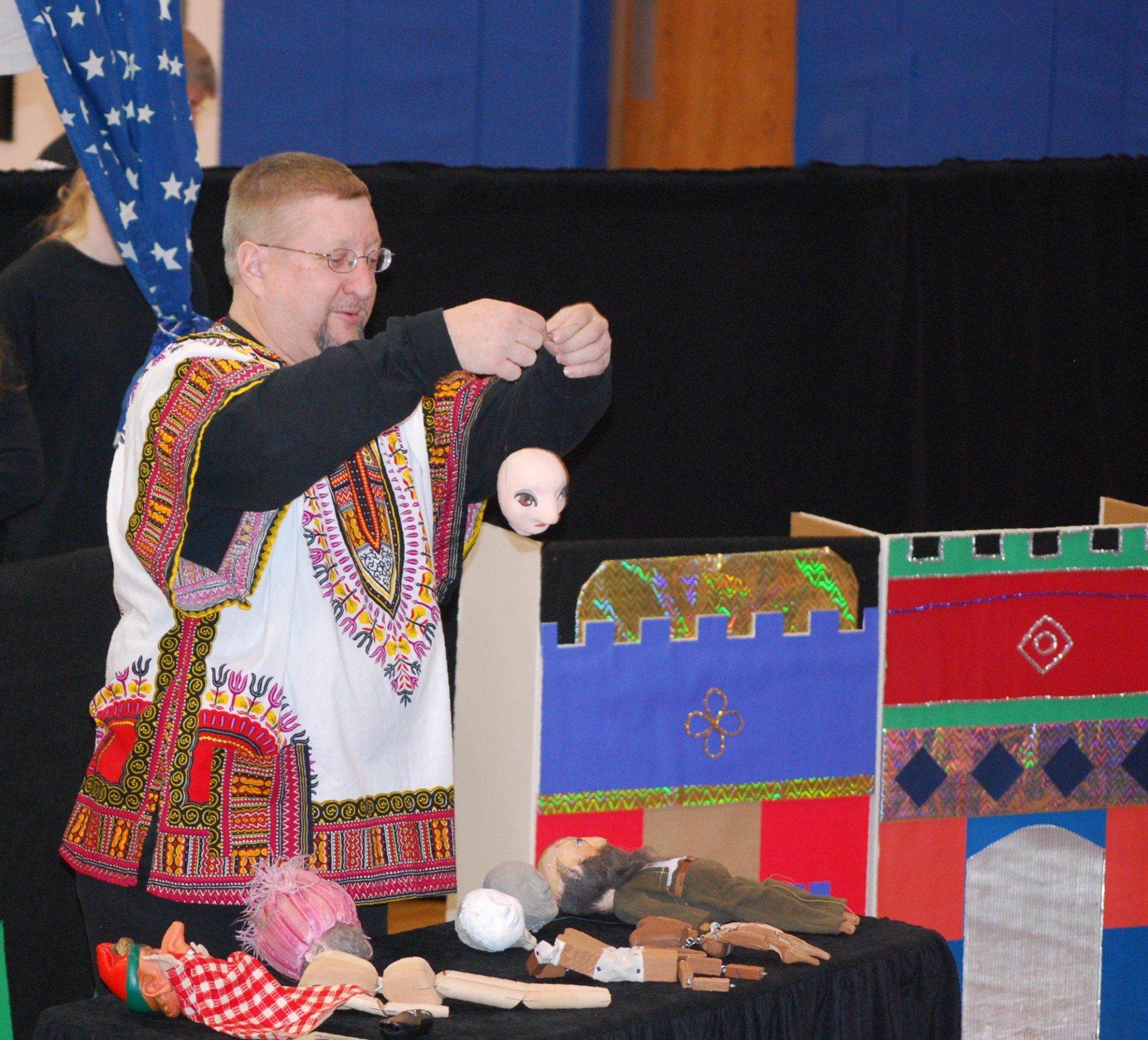 Mr. Dave holds up an unpainted paper mache marionette head