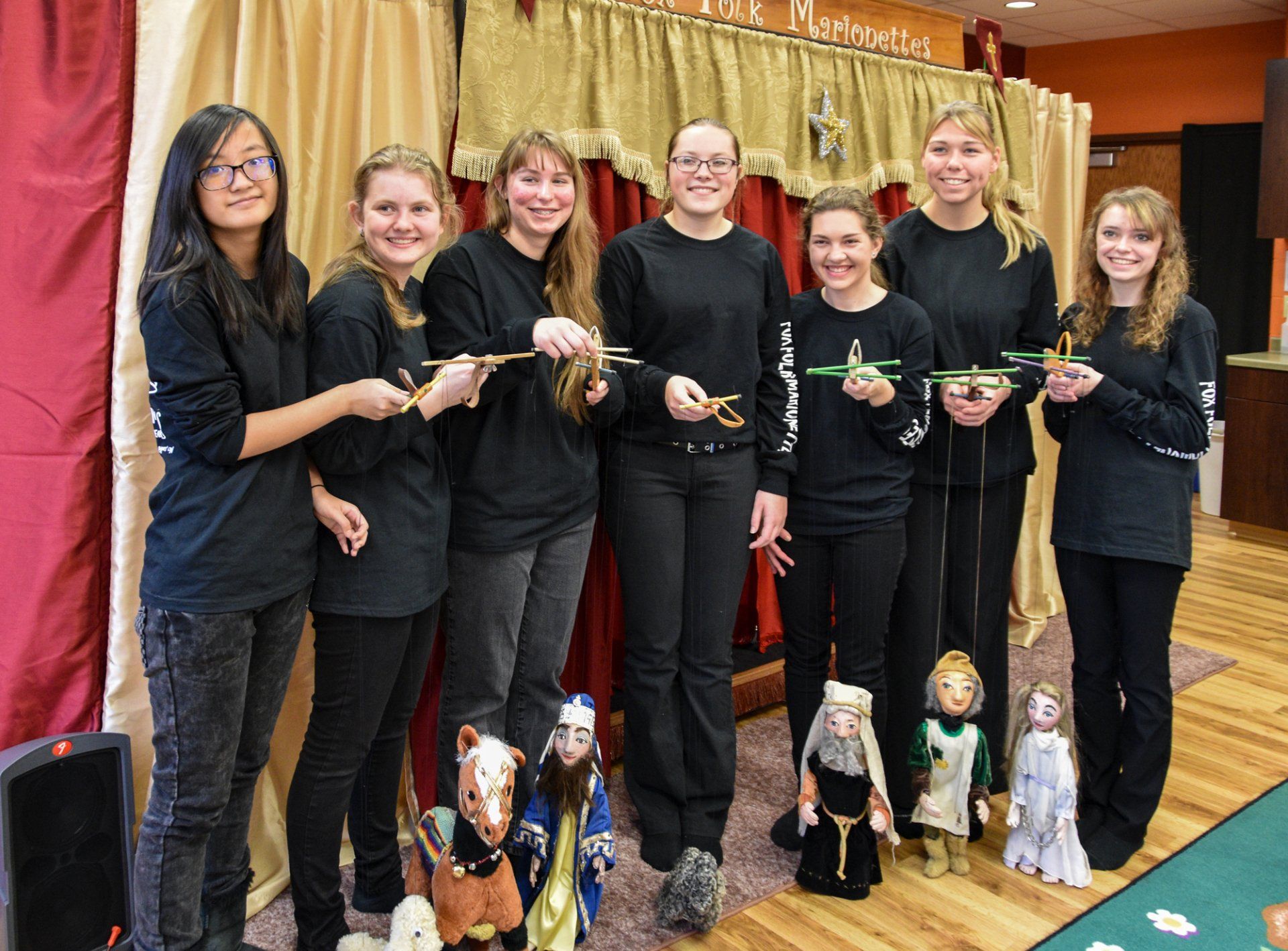group photo of puppeteers with marionettes