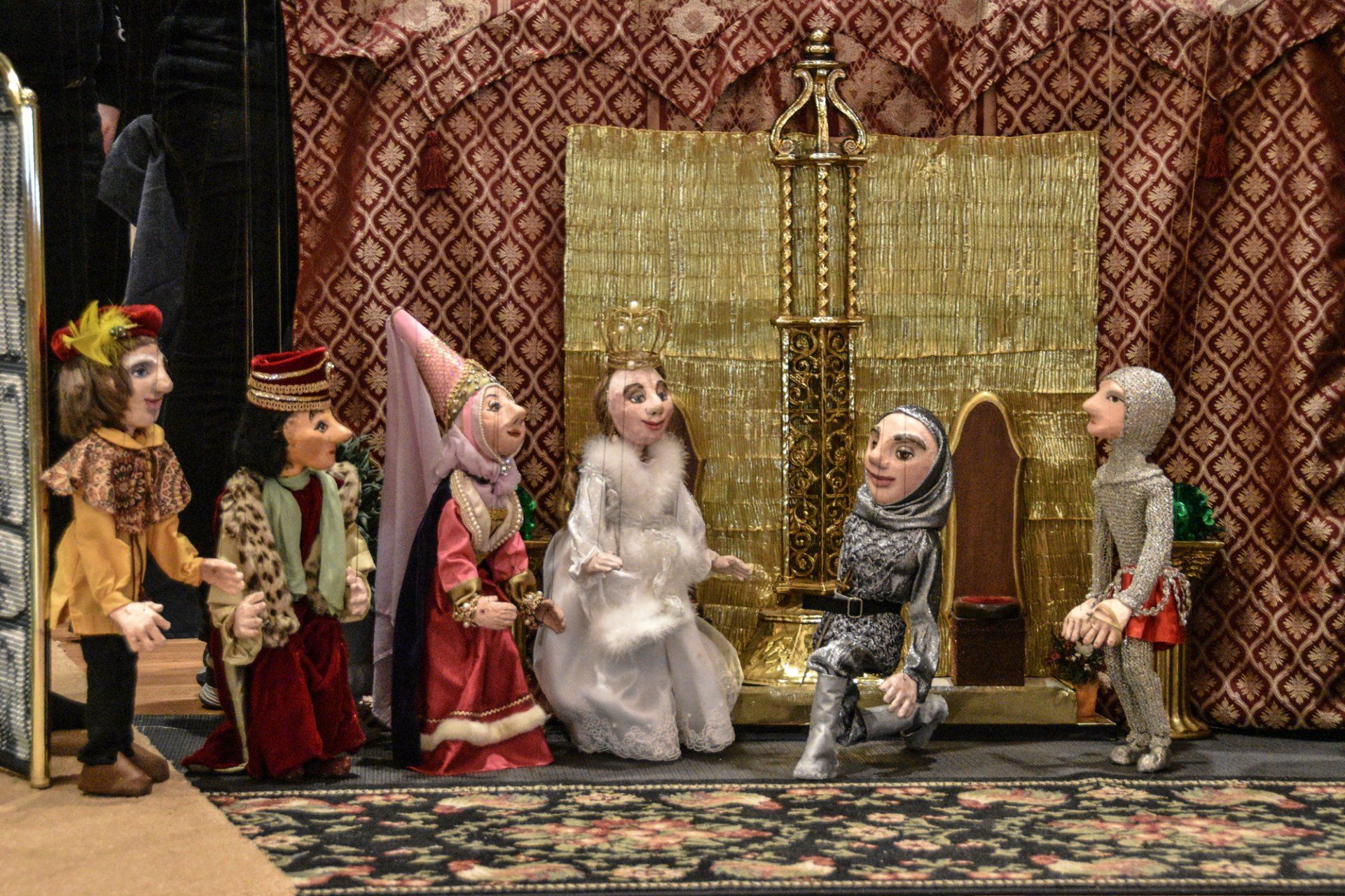 Six fairytale marionettes in the queen's throneroom
