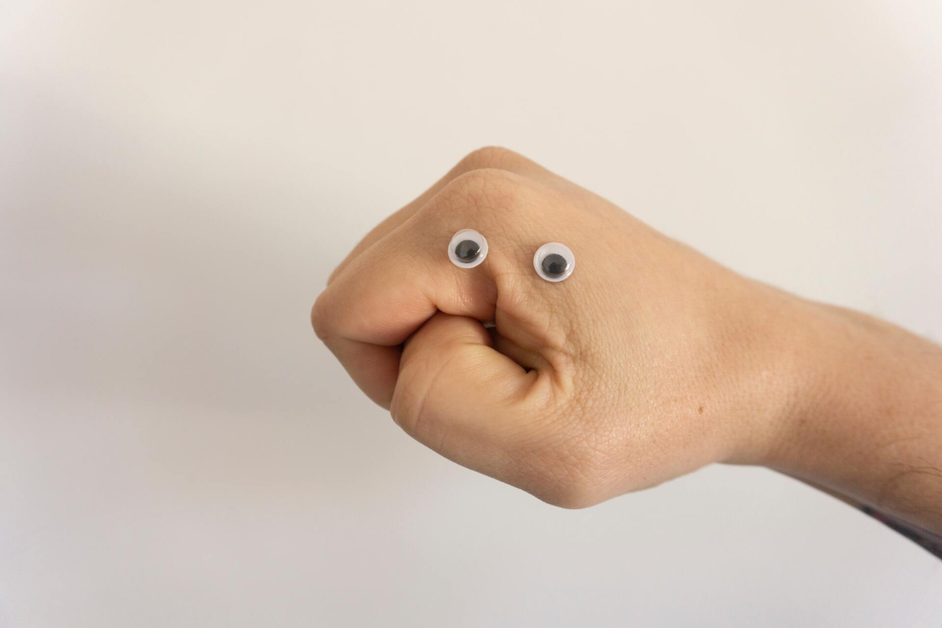 a simple puppet created by putting google eyes on a bare hand