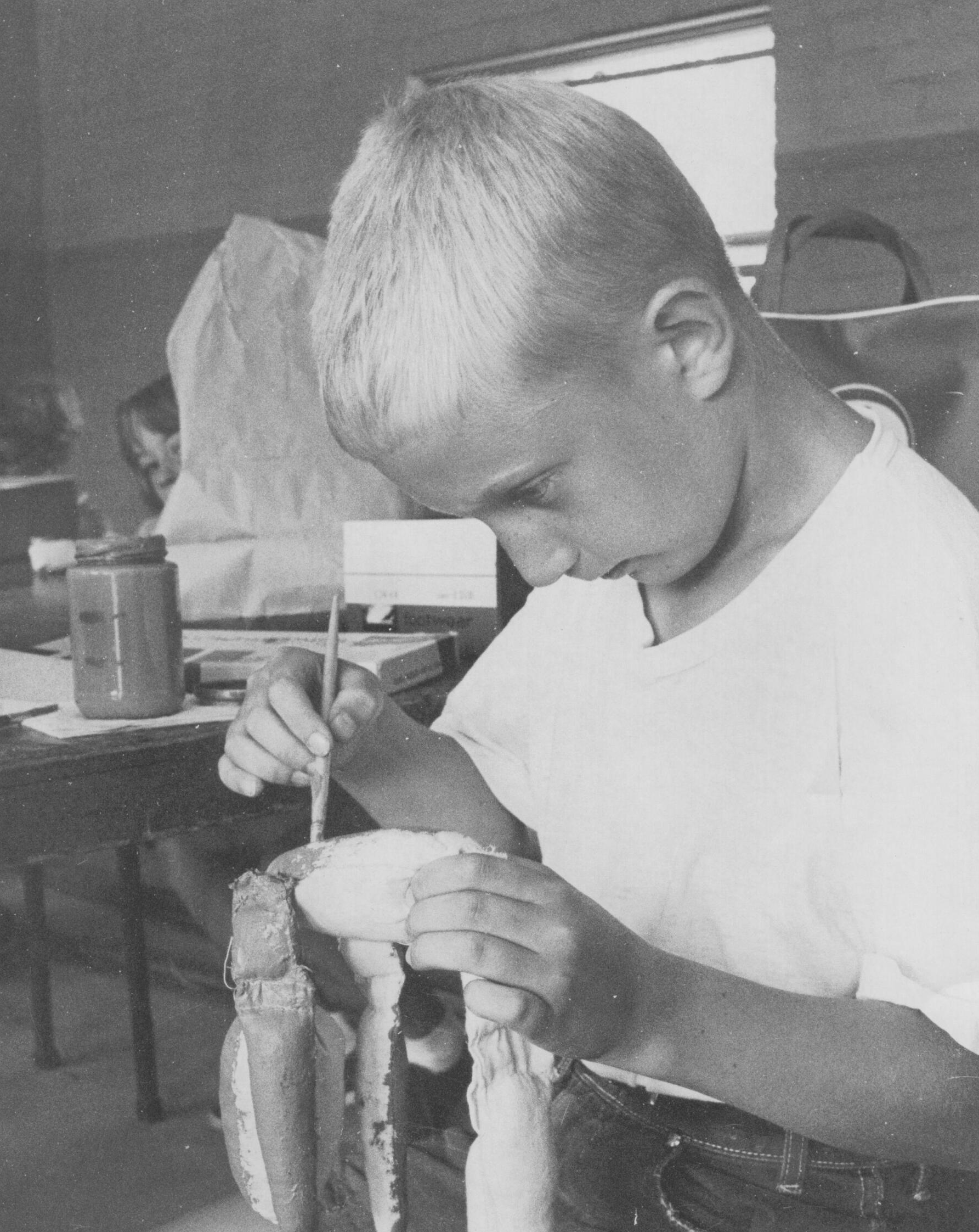 Mr. Dave as young student painting his marionette