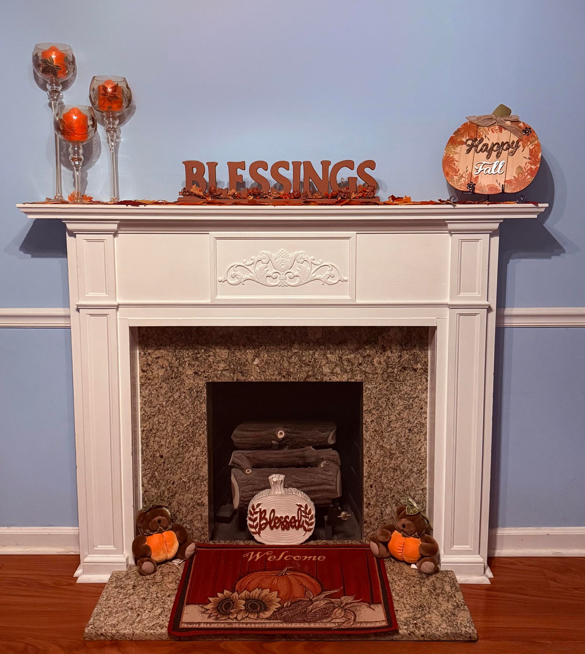 Fireplace mantel decorated for autumn with pumpkins and 