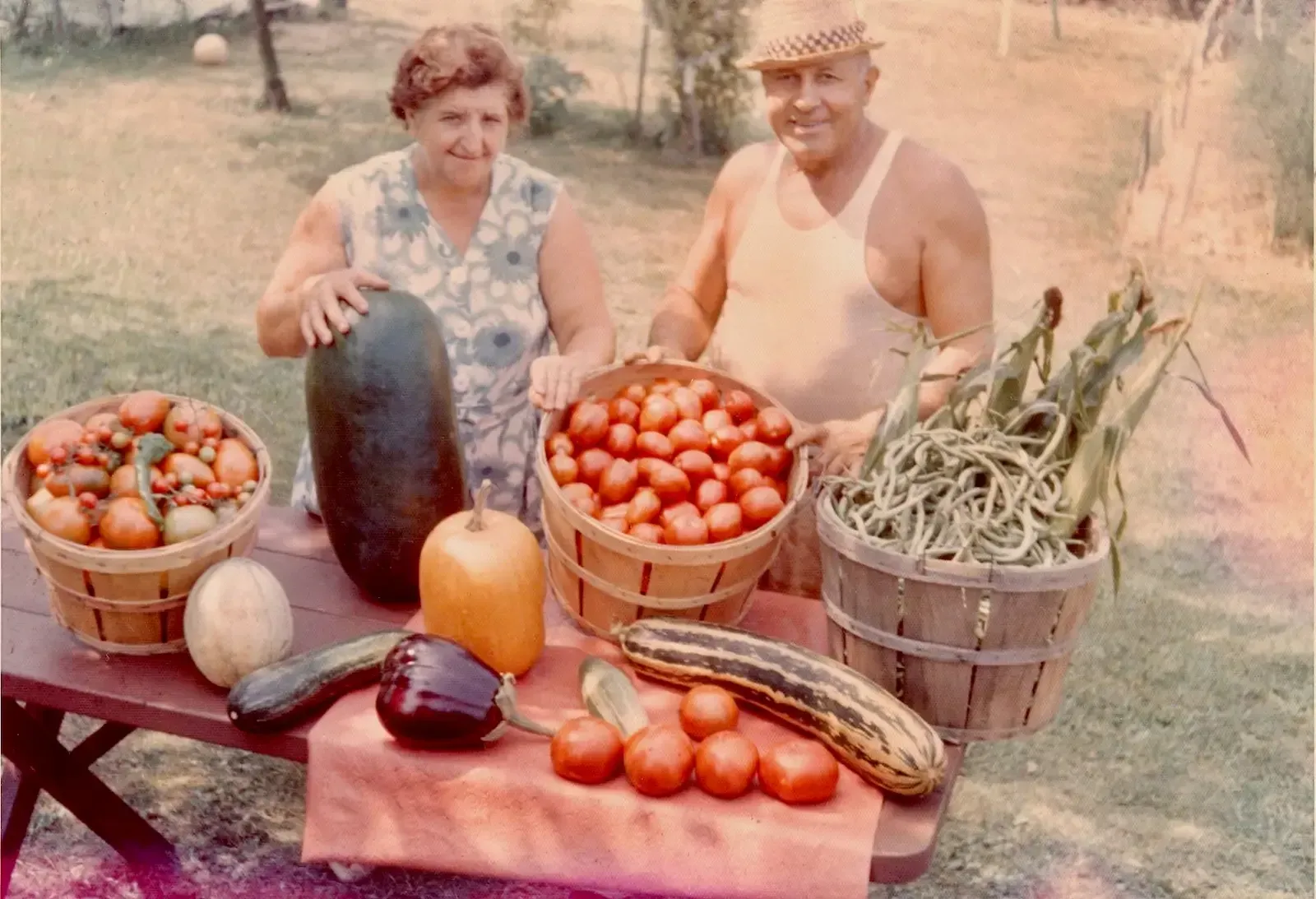Italian-American grandparents with baskets of fresh vegetables on their New Jersey farm in the 1960s