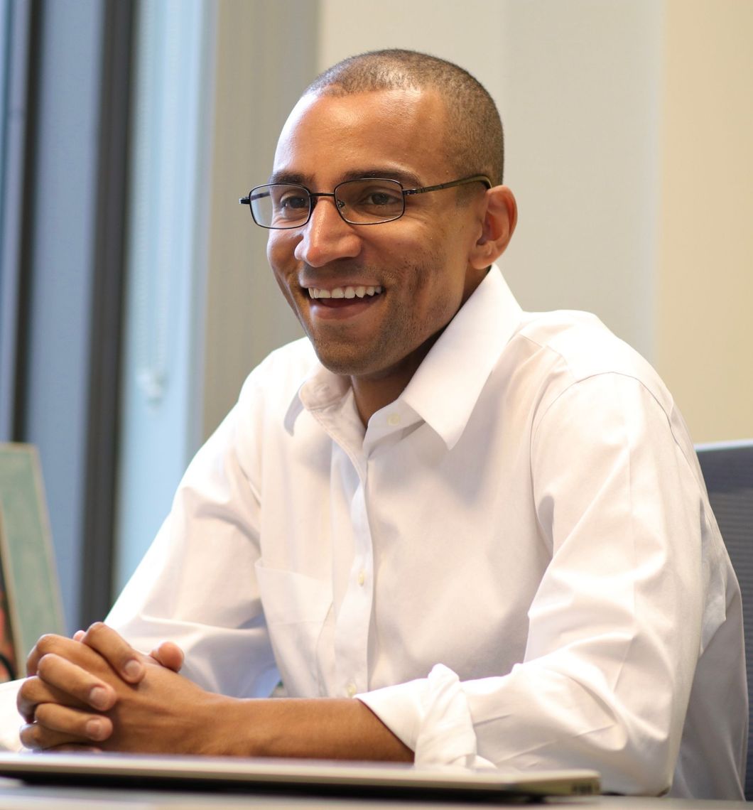 Photo of Jevon Gondwe in professional button down shirt with glasses