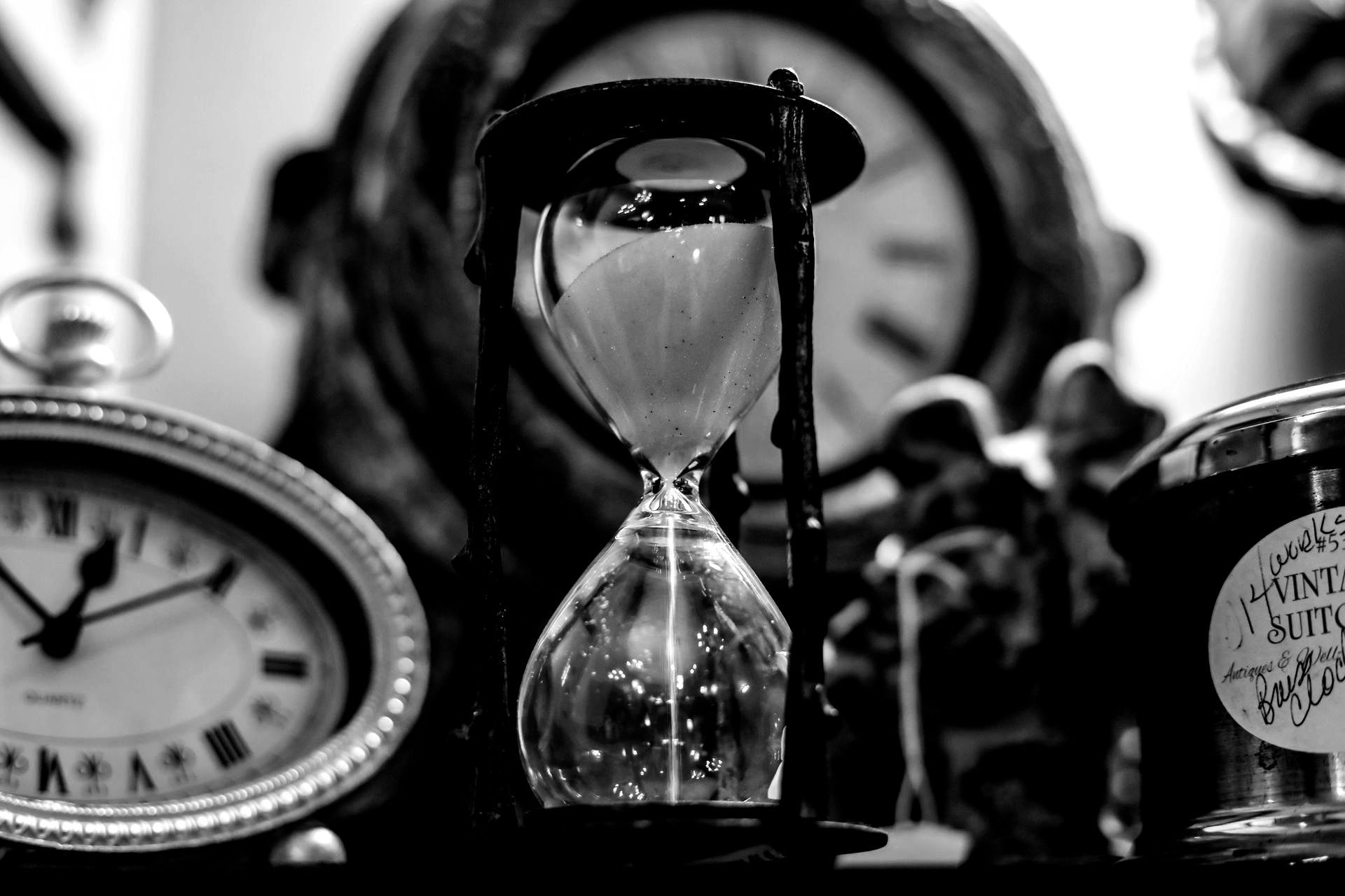 It is a black and white photo of a sand countdown timer showcasing the deadline is coming soon