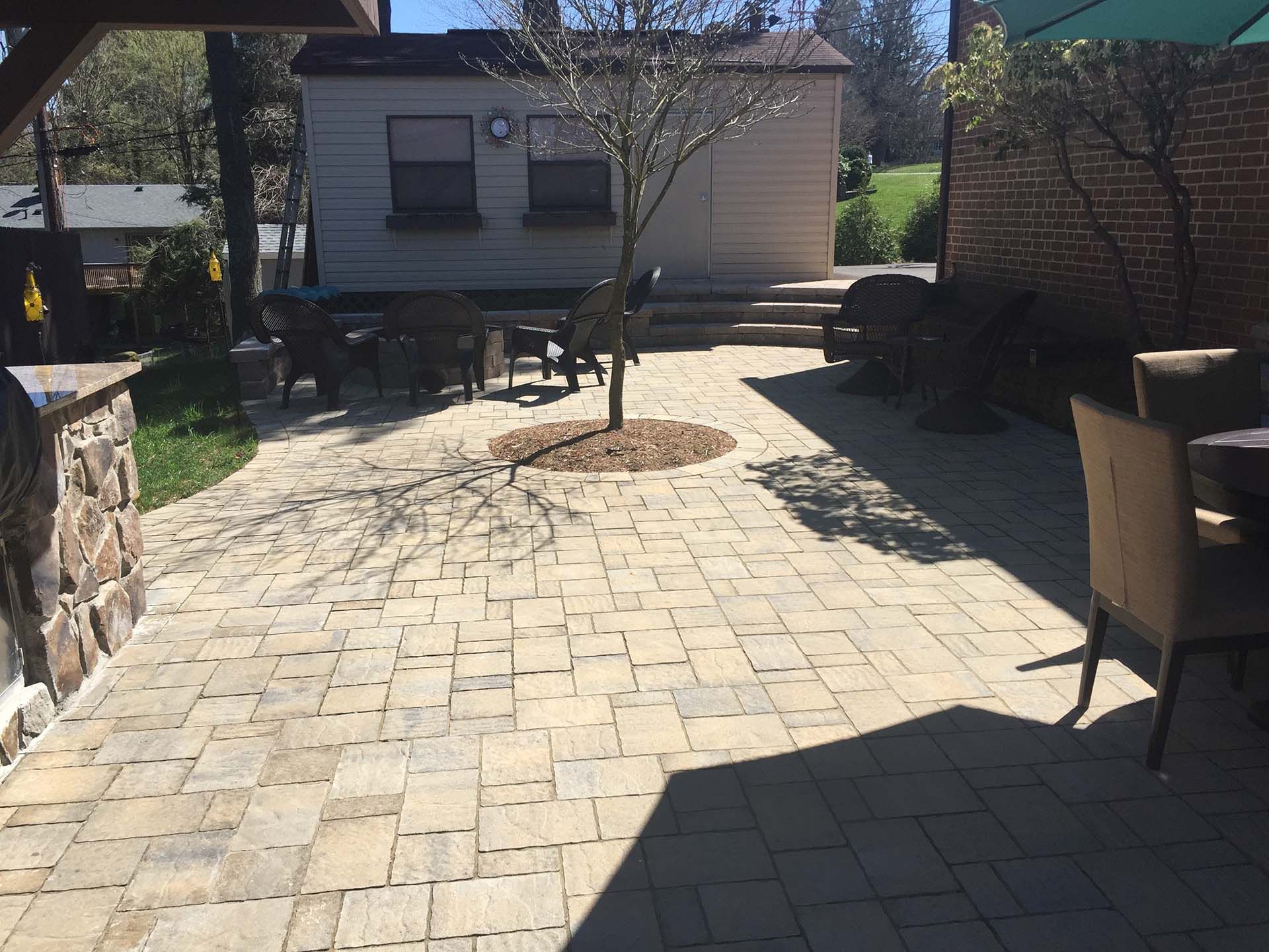 A patio with chairs in front of a house