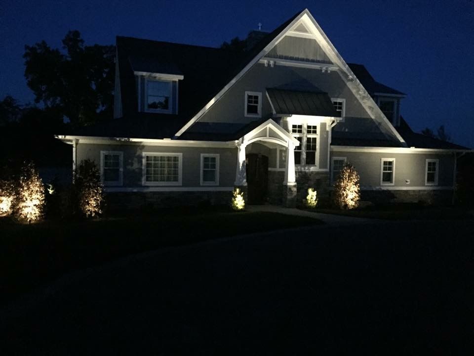 The front of a house is lit up at night