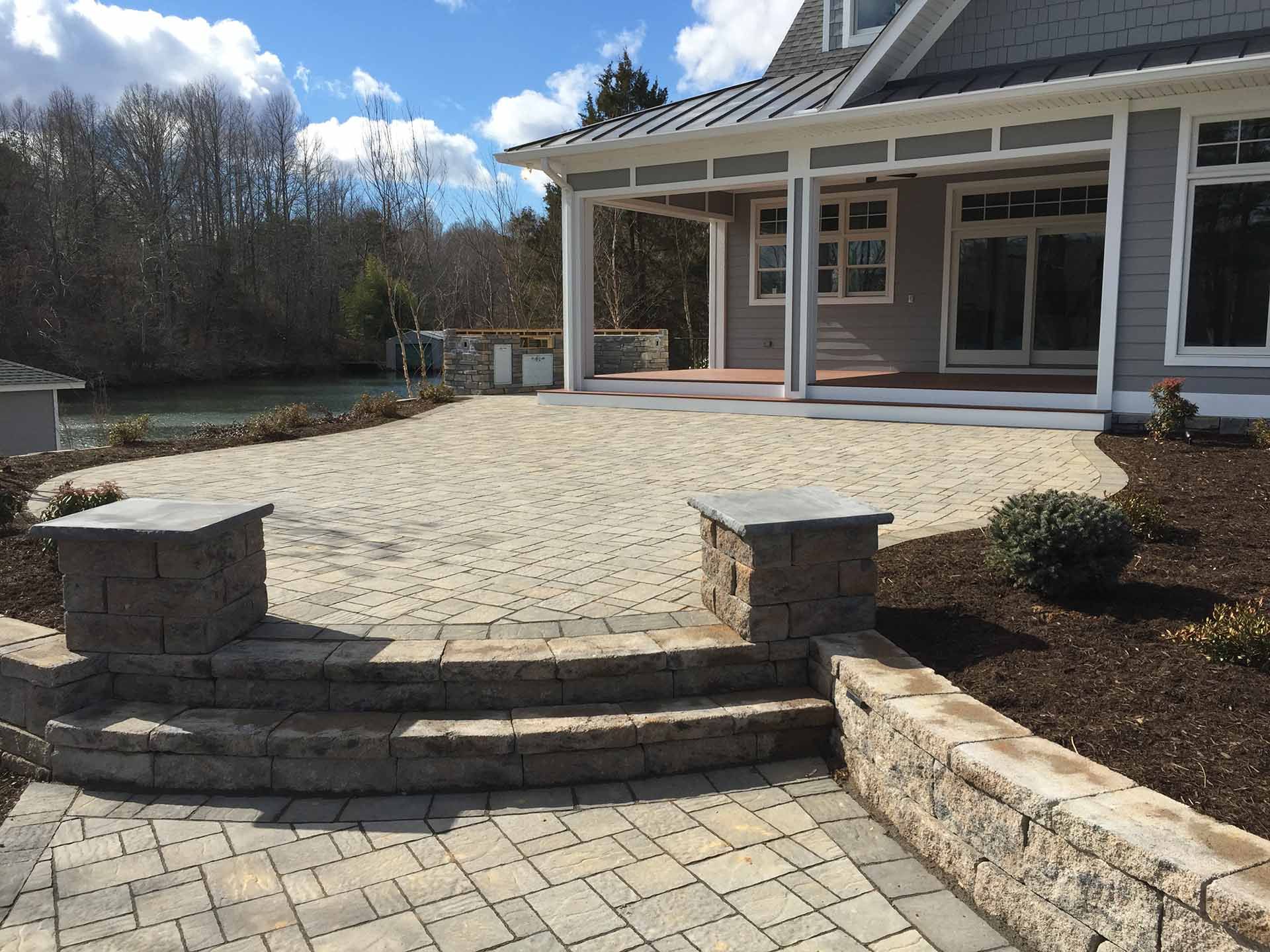 A house with a patio and stairs in front of it