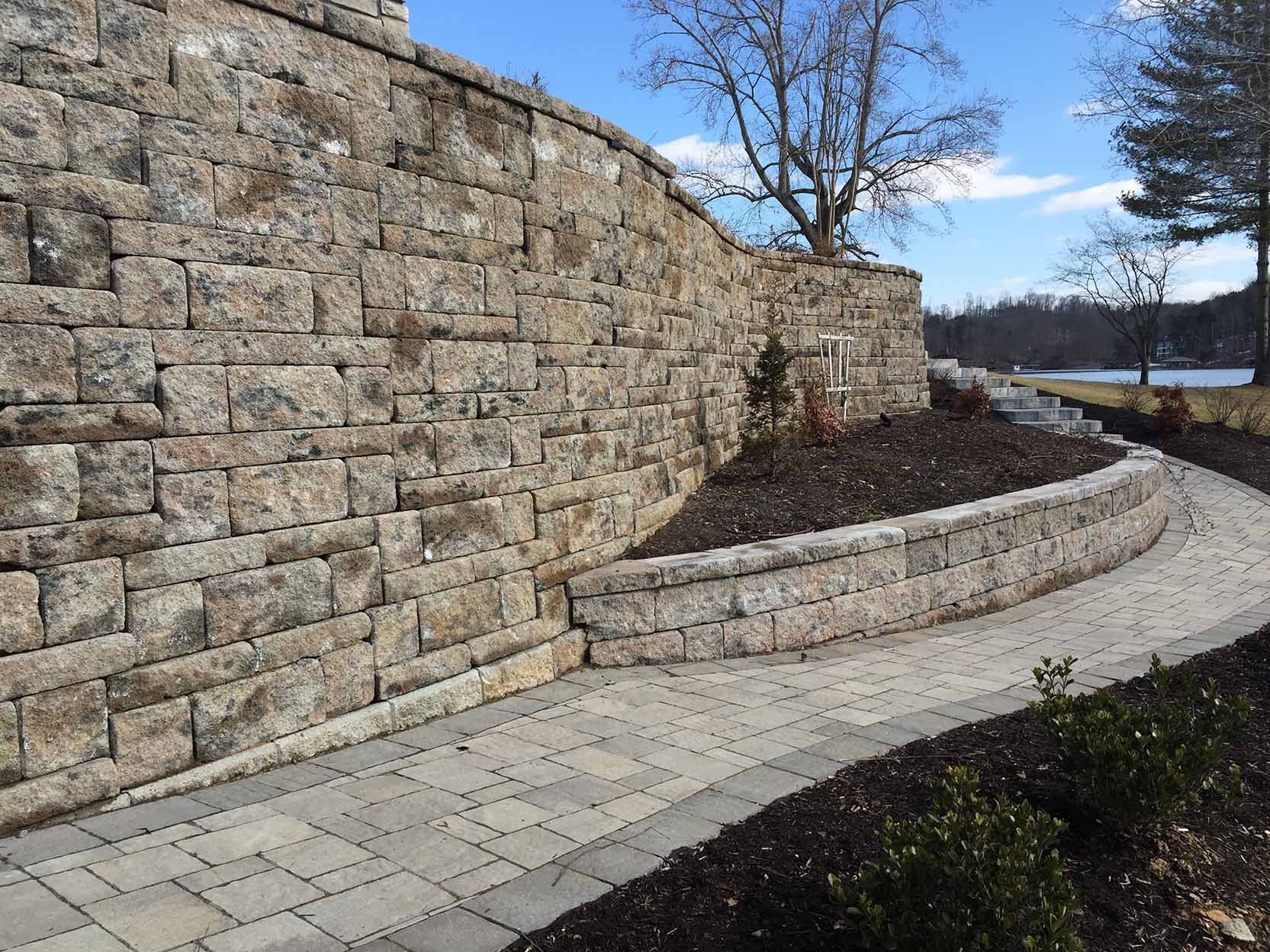 A stone wall with a walkway leading to it