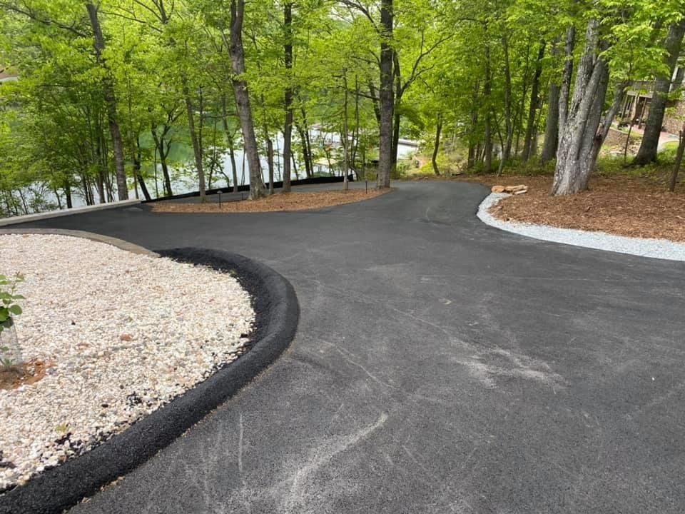 A curvy driveway surrounded by trees