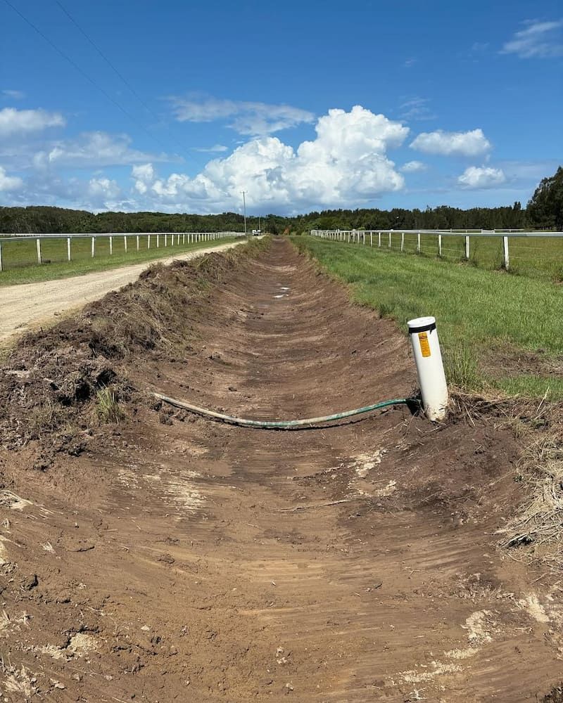 A Dirt Road With a White Pole in the Middle of It — Norcoast Diggers in Ballina, NSW