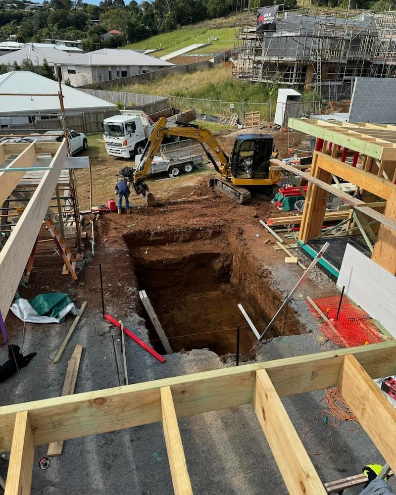 A Construction Site With a Excavator Digging a Hole in the Ground — Norcoast Diggers in Ballina, NSW