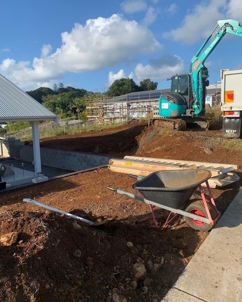 A Construction Site With a Wheelbarrow and Shovel in the Dirt — Norcoast Diggers in Byron Bay, NSW