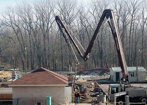 A crane used for a concrete pumping services near Chicago, IL