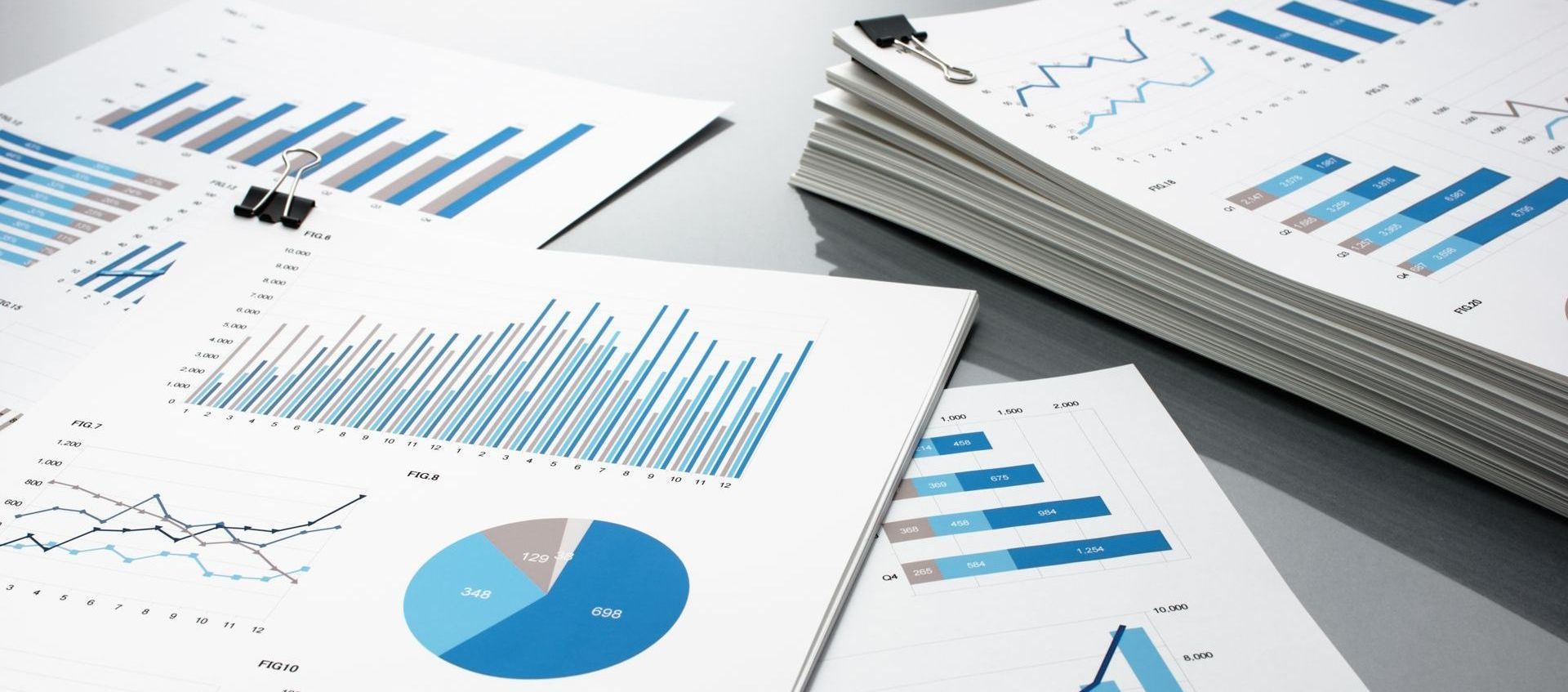a stack of papers labeled with graphs and statistics