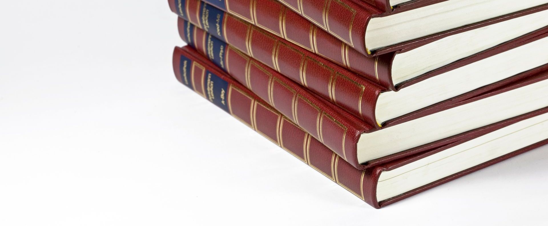 a stack of hardbound almanacs with gold foiled spines