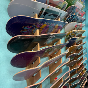 Stacked colorful skateboards on a store display rack