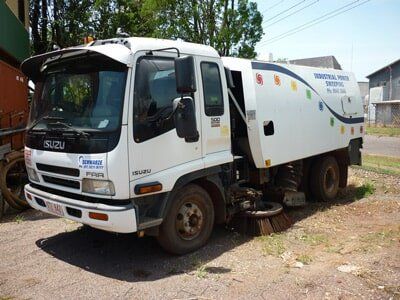 White Isuzu street sweeper truck parked outdoors  — Industrial Power Sweeping Services Pty Ltd In Knuckey Lagoon, NT