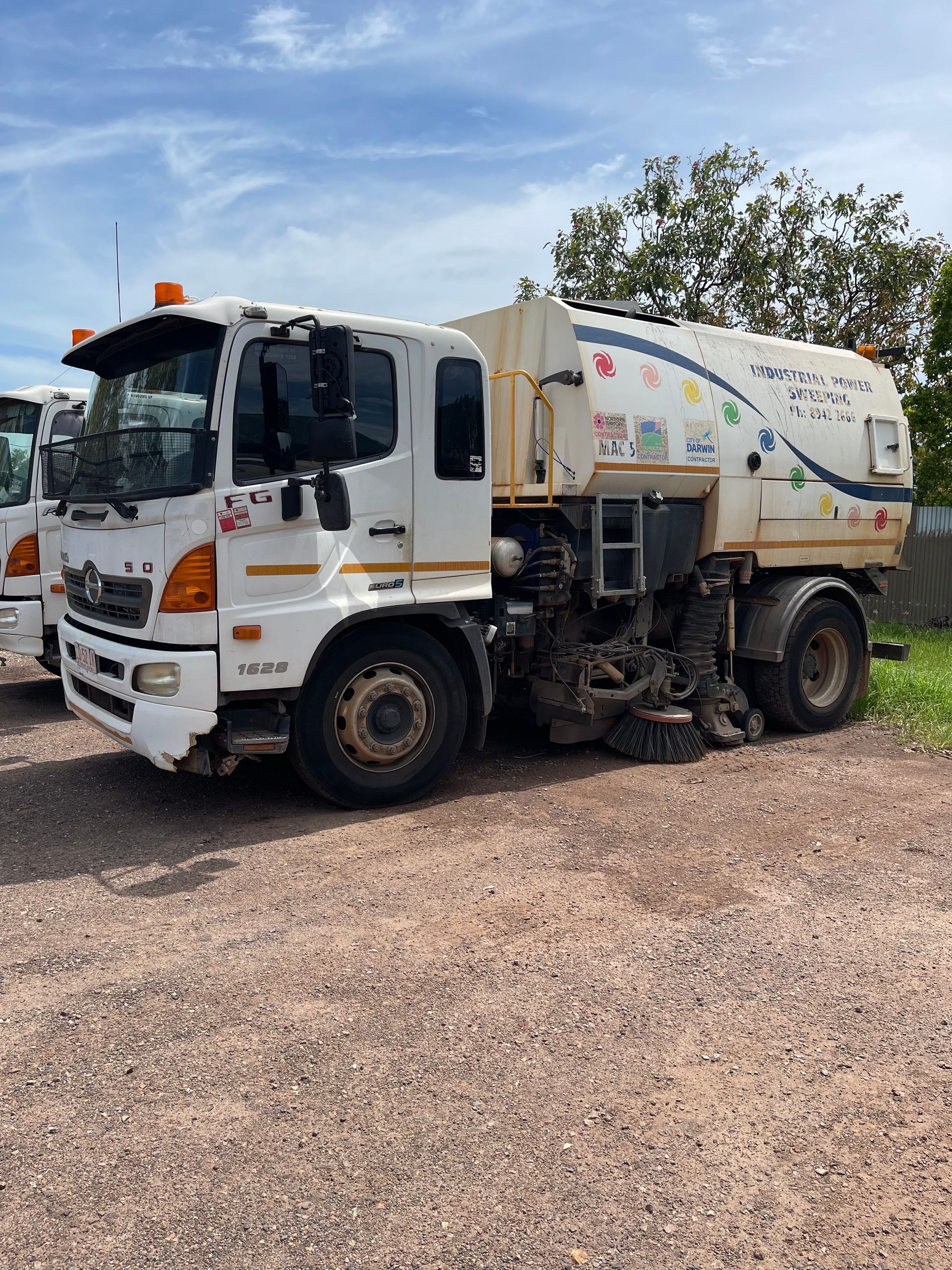 White street sweeper truck parked on gravel  — Industrial Power Sweeping Services Pty Ltd In Knuckey Lagoon, NT