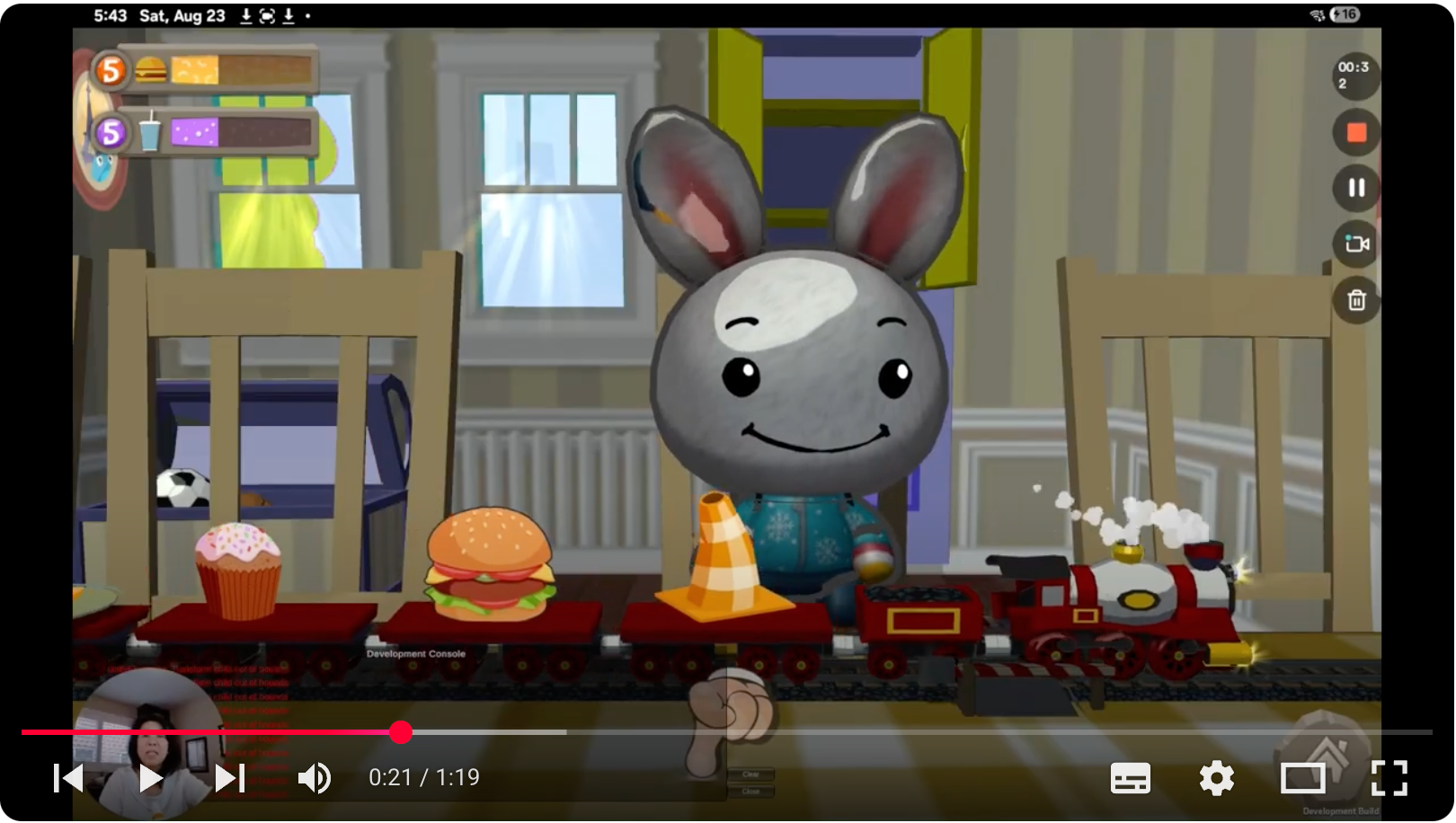 Father and two young children playing video games on a couch.