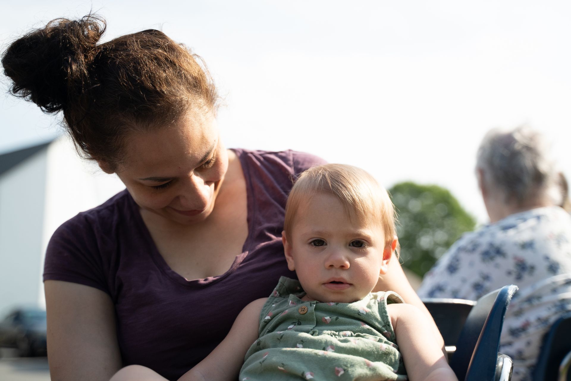 Mom, Autumn, holds her 16 month old, Joslyn, as they wait for the Connecticut Foodshare mobile food pantry to begin.