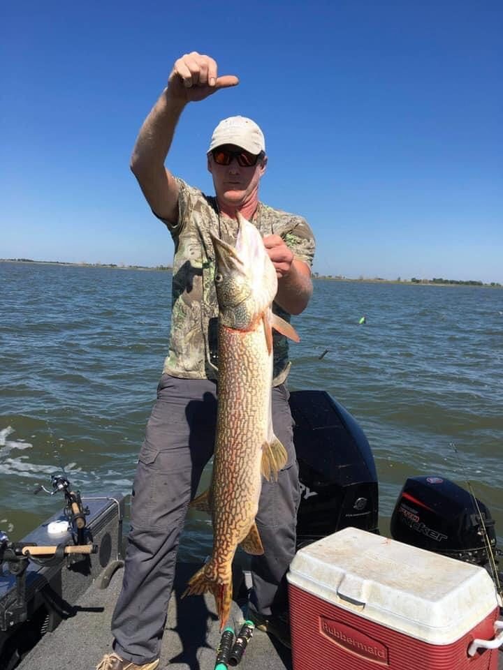 Man holding large pike on Lake Thompson, South Dakota