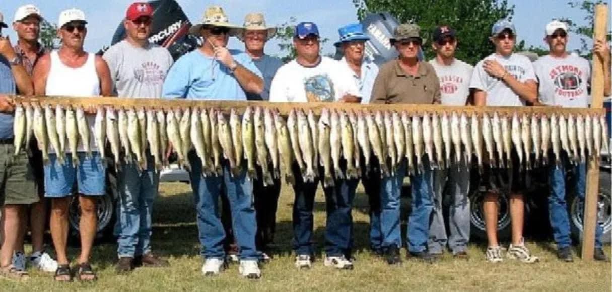 Group of 5 people holding day's catch of multiple species of fish