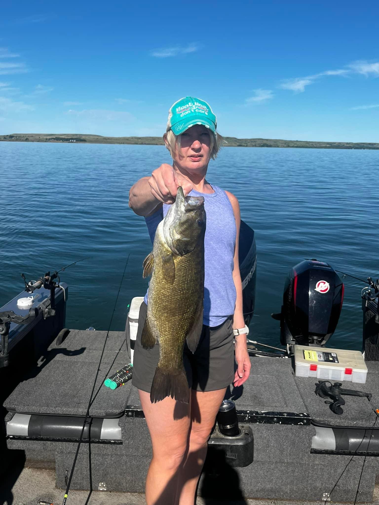 Woman holding South Dakota bass