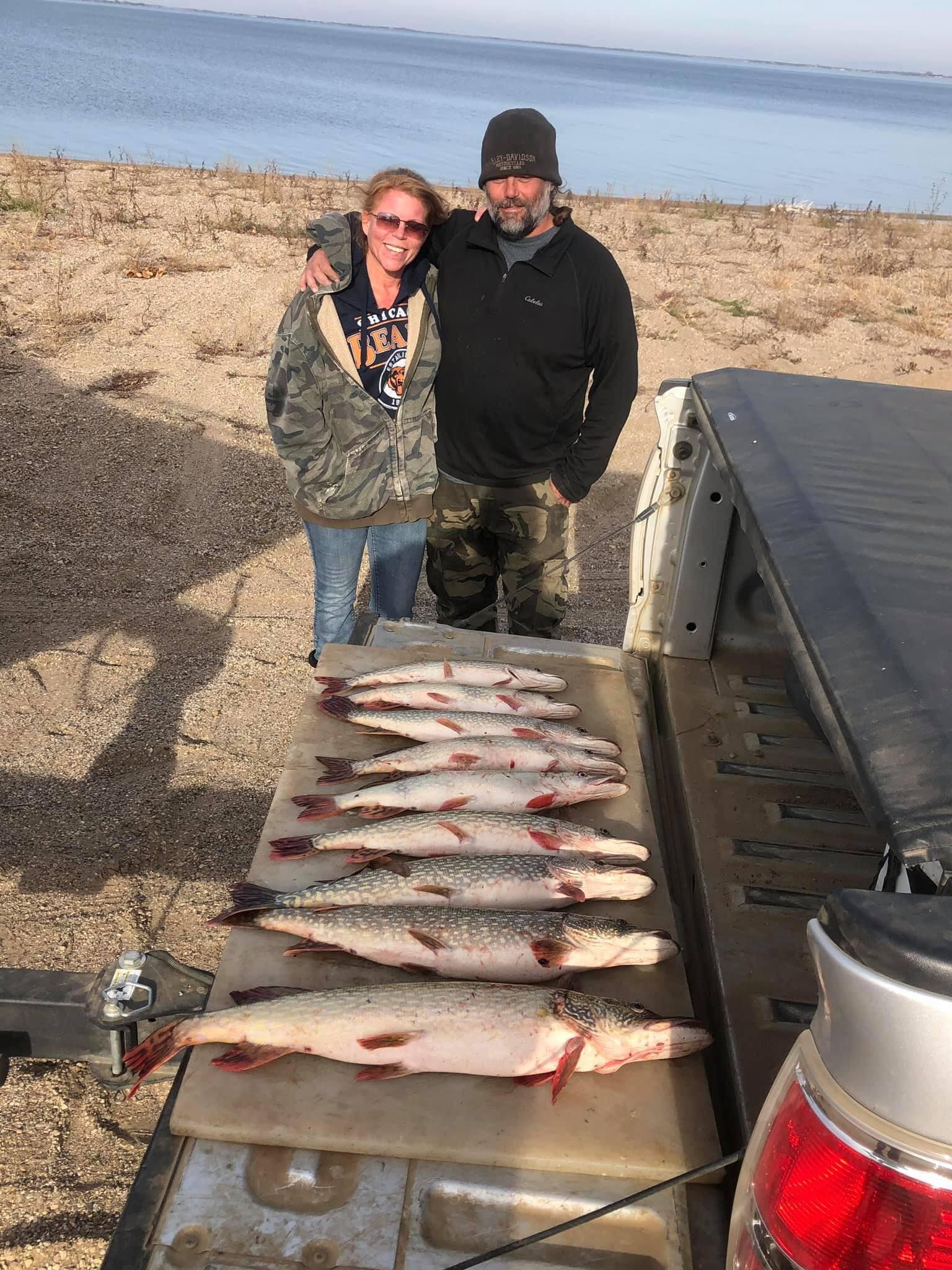 Young couple with days catch of fish on Lake Thompson, South Dakota