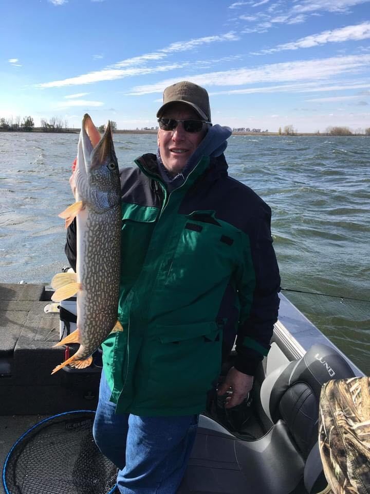 Man holding northern pike, Lake Thompson, SD