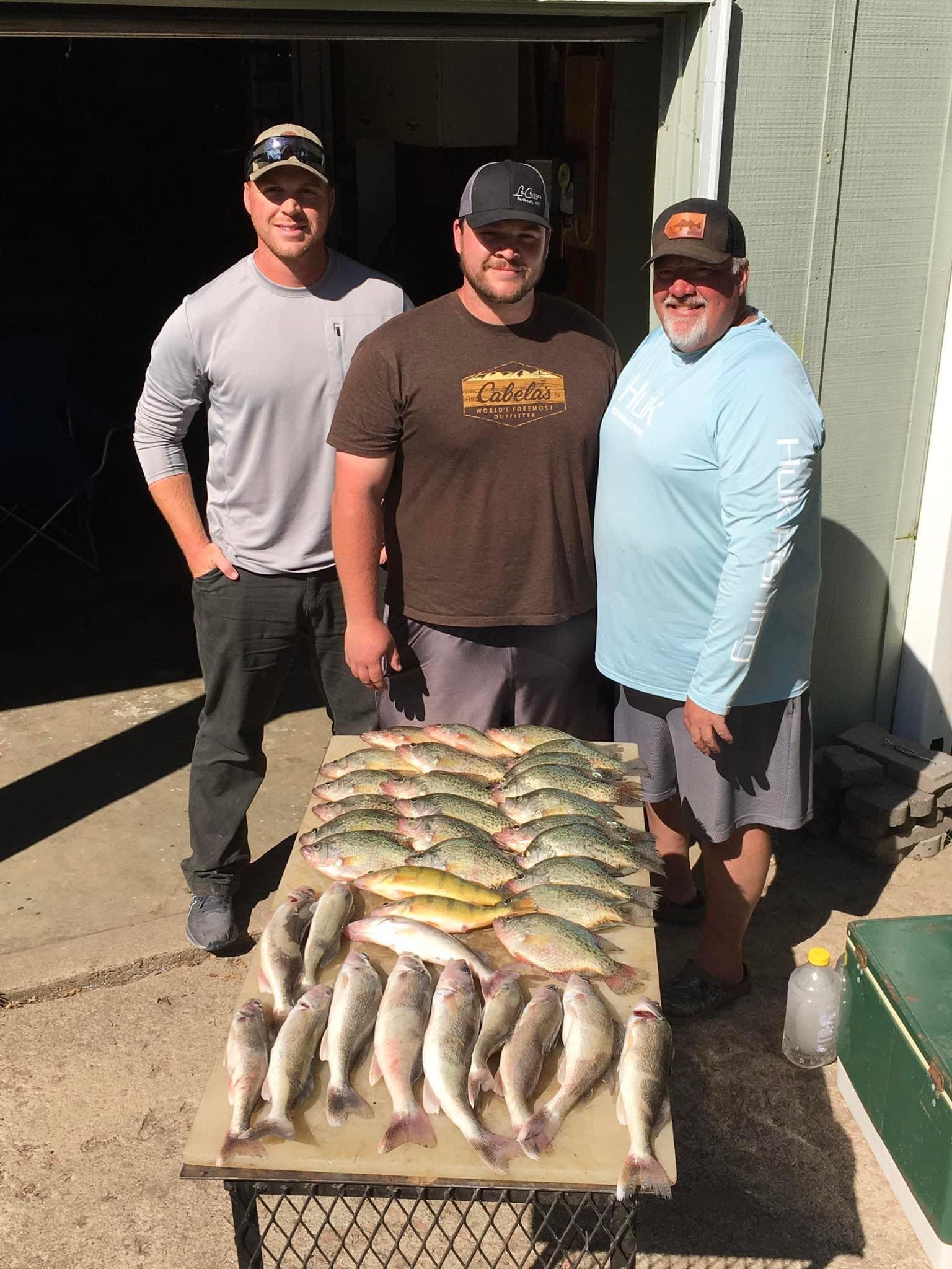 Father and sons with days catch of walleye, Lake Thompson SD