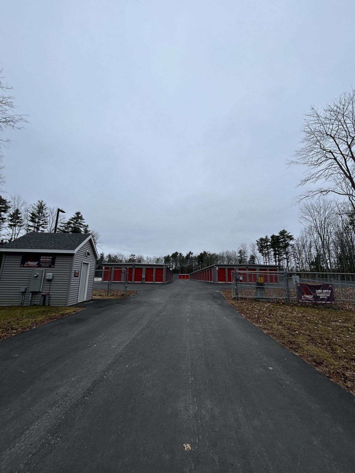 A road leading to a storage facility on a cloudy day.