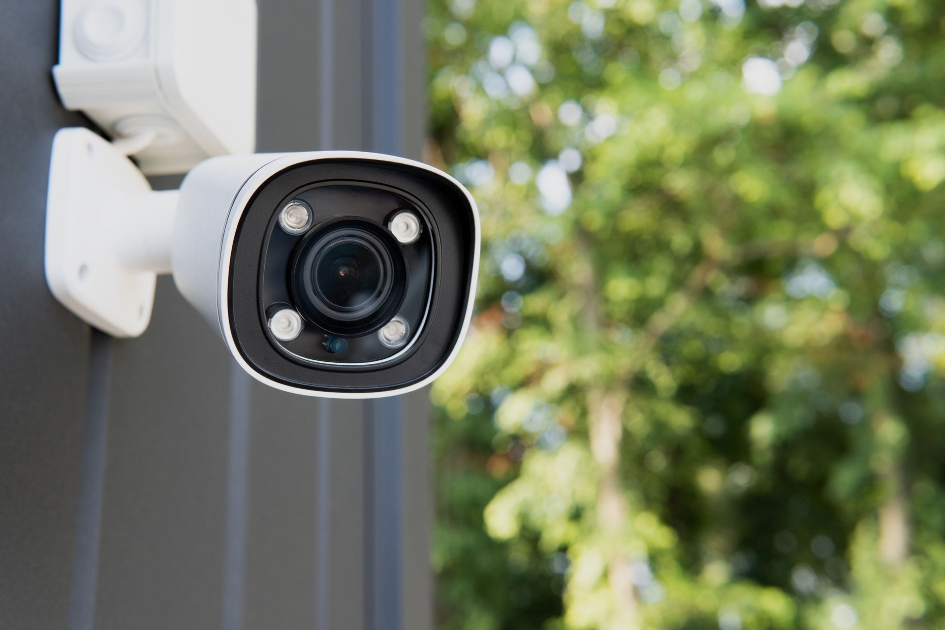 A security camera is mounted on the side of a building.