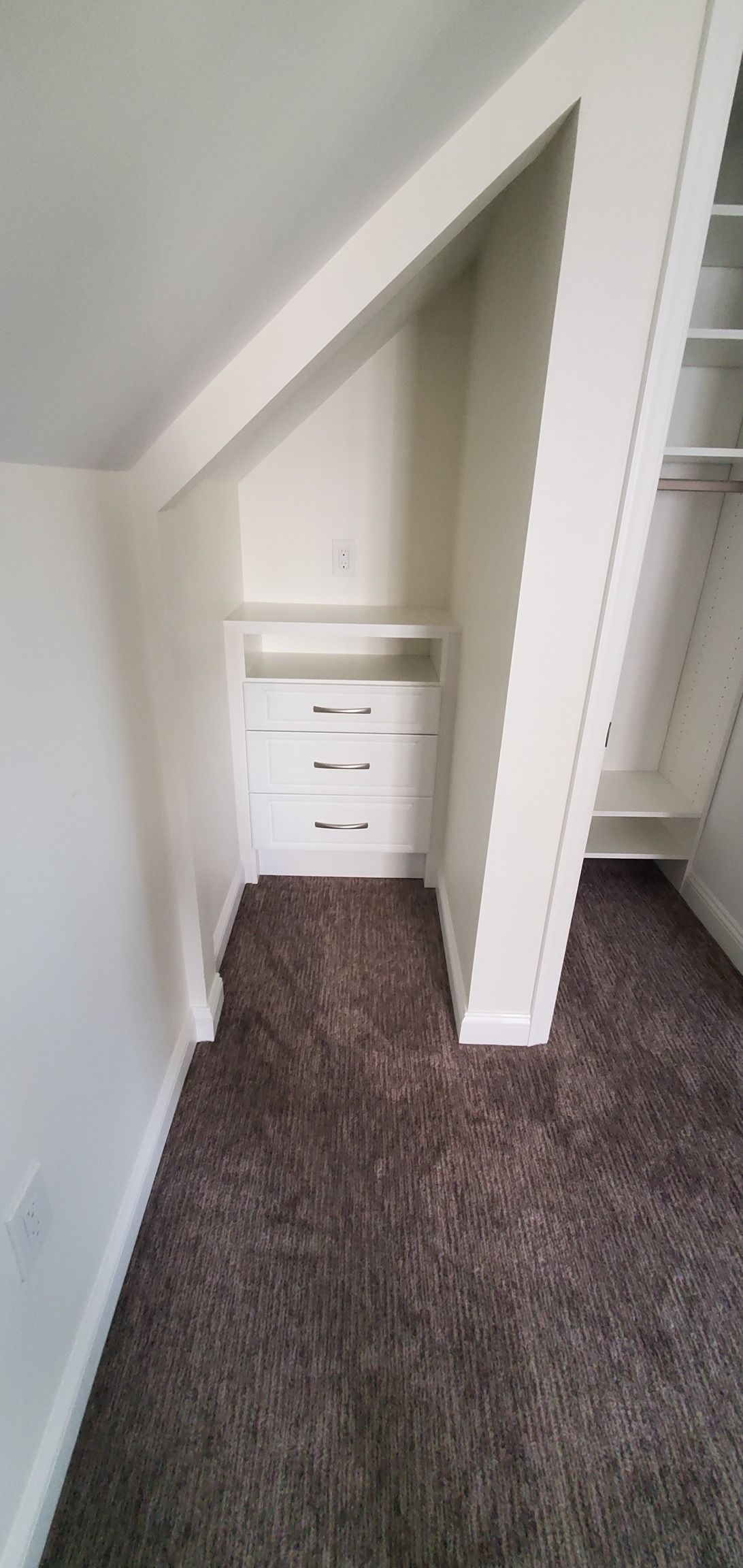 There is a closet under the stairs in the corner of the room.