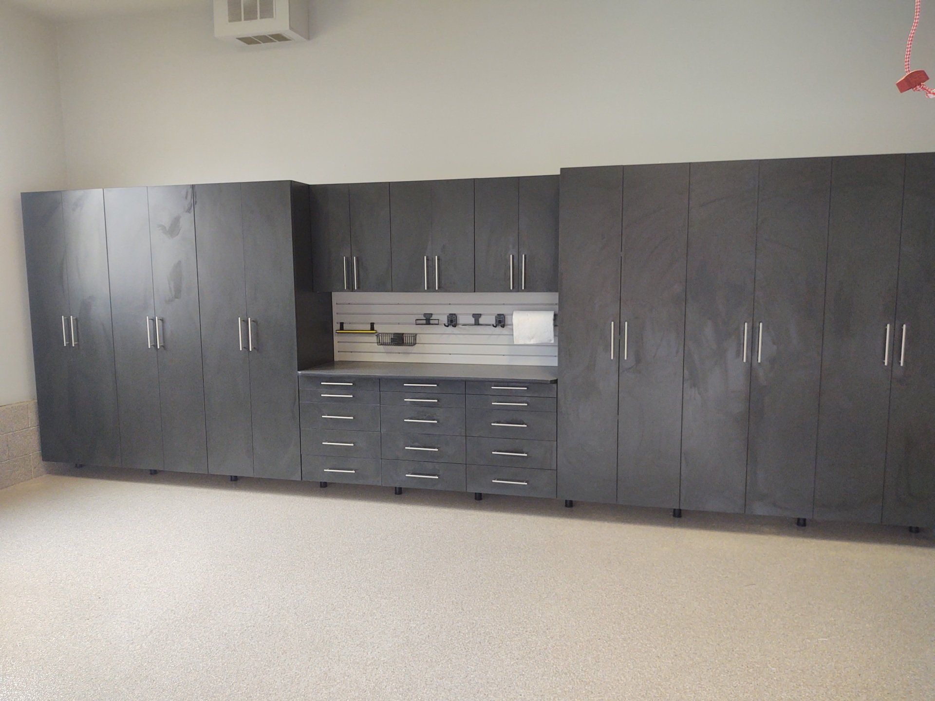A garage with a lot of cabinets and drawers