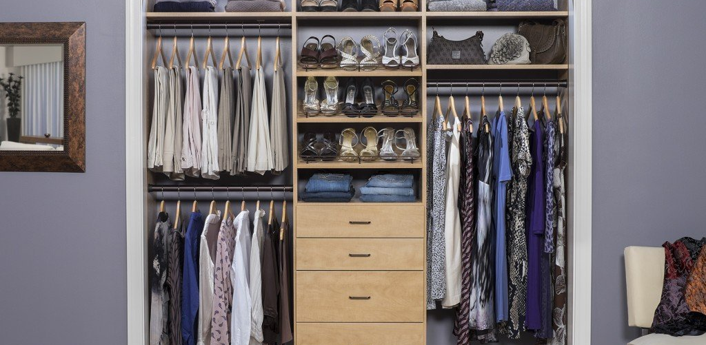 A closet filled with lots of clothes and shoes