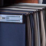 A close up of a dishwasher with a bunch of clothes hanging on it.