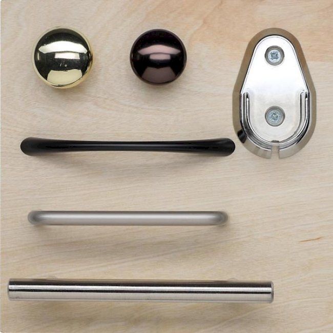 A bunch of handles and knobs on a wooden surface